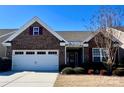 Charming brick home featuring a well-manicured lawn and a two-car garage at 156 Carmen Way, Lancaster, SC 29720