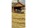 Wooden cabin with covered porch and picnic table, situated in a field at 166 Cheryls Pass None, Love Valley, NC 28625