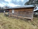 Rustic cabin exterior with wooden siding and a single window at 166 Cheryls Pass None, Love Valley, NC 28625