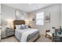 Cozy bedroom with a queen bed, side tables, and a sitting chair at 1709 Honey Trl, Monroe, NC 28112