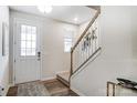 Front entry with white door, stairs, and wood-look flooring at 1709 Honey Trl, Monroe, NC 28112