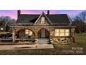 Charming stone house exterior at dusk, showing illuminated windows at 200 Church Dr, Shelby, NC 28150