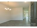 Bright dining room with chandelier and gray vinyl plank flooring at 2238 Catawba Trace Dr, Catawba, NC 28609