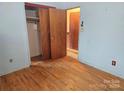 Simple bedroom with wood floors and a double door closet at 2518 Cove Creek Dr, Gastonia, NC 28056