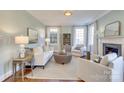 Light-filled living room with comfortable seating and a cozy fireplace at 2912 Park Rd, Charlotte, NC 28209