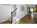 Elegant hardwood staircase with black metal railing in the foyer at 3719 13Th Ne St, Hickory, NC 28601