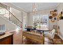 Dining area with wood floors, a black table, and a staircase visible in the background at 4119 Flint Dr, Lancaster, SC 29720