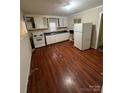 Simple kitchen featuring white cabinets and laminate floors at 415 Sherman St, Gastonia, NC 28052