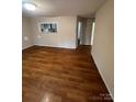 Open living area with wood-look floors and access to kitchen at 415 Sherman St, Gastonia, NC 28052