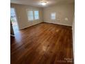 Living room with wood-look floors and large windows at 415 Sherman St, Gastonia, NC 28052