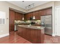 Modern kitchen with granite countertops and stainless steel appliances at 4620 Piedmont Row Dr # 608, Charlotte, NC 28210