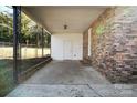 Covered back porch with storage room and brick wall at 4804 Chapel Grove Rd, Gastonia, NC 28052