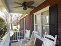 Front porch with rocking chairs, brick columns, and window shutters at 4819 Vander Ln # 54, Monroe, NC 28110