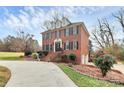 Well-manicured brick home with dormer windows and a brick walkway at 503 Bridgestone Ct, Gastonia, NC 28056