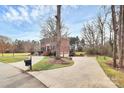 A classic brick home with a circular driveway and lush landscaping at 503 Bridgestone Ct, Gastonia, NC 28056