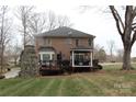 Brick house with deck, gazebo, and stone fireplace in backyard at 503 Bridgestone Ct, Gastonia, NC 28056