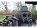 Outdoor stone fireplace on deck with seating area at 503 Bridgestone Ct, Gastonia, NC 28056