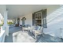 Relaxing front porch with comfortable seating and grey shutters at 506 S Chester St, Gastonia, NC 28052