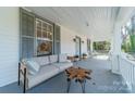 Inviting front porch featuring a stylish sofa and coffee table at 506 S Chester St, Gastonia, NC 28052