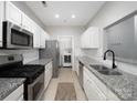 Modern kitchen, granite countertops, stainless steel appliances, and white cabinets at 5617 Fairview Rd # 9, Charlotte, NC 28209