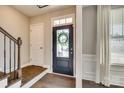 Elegant front entry with a dark door and wreath at 6265 Six String Ct, Fort Mill, SC 29708