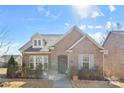 Brick home with gray door, landscaping, and walkway at 703 Marion Dr, Matthews, NC 28105