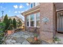 Stone patio with bench and potted plants next to house at 703 Marion Dr, Matthews, NC 28105