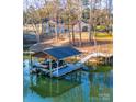 Private boat dock with covered slip and floating dock, perfect for lake access at 7476 Point St, Denver, NC 28037