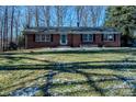 Brick ranch house with a spacious lawn and mature trees at 940 Valley Dr, Newton, NC 28658