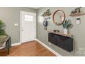 Bright entryway with wood floors and a custom floating shelf at 941 Squirrel Hill Rd, Charlotte, NC 28213