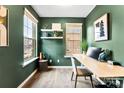 Home office with green walls and built-in shelving at 1135 Doveridge St, Charlotte, NC 28273