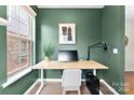 Green-walled home office with a standing desk at 1135 Doveridge St, Charlotte, NC 28273