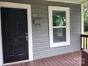 Black front door with white trim, and a mailbox on the porch at 1302 Brookdale St, Kannapolis, NC 28083