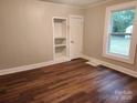 Living room with wood-look flooring and built-in shelving at 1302 Brookdale St, Kannapolis, NC 28083