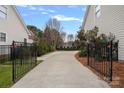 Long driveway with black metal gates on either side at 14214 Sullivan Watch Dr, Huntersville, NC 28078