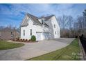 Three car garage with long driveway and landscaped yard at 2010 Belle Grove Dr, Marvin, NC 28173
