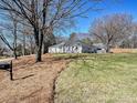 Ranch home with mature trees, manicured lawn, and a large front yard at 2300 Hamilton Mill Rd, Charlotte, NC 28270