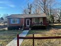 Brick ranch house with a porch and a fenced yard at 2327 Catalina Ave, Charlotte, NC 28206