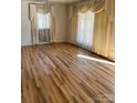 Spacious living room featuring hardwood floors and large windows at 2327 Catalina Ave, Charlotte, NC 28206