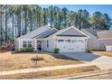 Charming one-story home with gray siding, stone accents, and a two-car garage at 525 Grandiflora Ave # 101, Lancaster, SC 29720