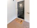Front door entry with a welcome mat at 6416 Park Pond Dr, Charlotte, NC 28262