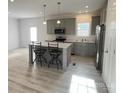 Well-lit kitchen with gray cabinets, stainless steel appliances, and island seating at 819 Wellwood Ave, Statesville, NC 28677