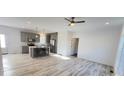 Open-concept living space featuring a kitchen island, stainless appliances, and hardwood flooring at 819 Wellwood Ave, Statesville, NC 28677