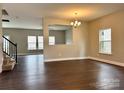 Bright living room featuring hardwood floors, a staircase, and neutral paint at 9034 Seamill Rd, Charlotte, NC 28278