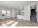 Open-concept living space featuring hardwood floors and a kitchen island at 1104 Verdigris Dr # 803/0803, Gastonia, NC 28054