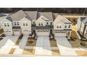 Aerial view of townhomes with attached garages and driveways at 11234 Bartrams Way, Charlotte, NC 28278