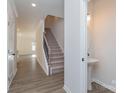 Inviting entryway featuring hardwood floors, stairs, and a convenient powder room at 1169 Red River Dr, Salisbury, NC 28144