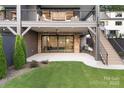 Backyard features a covered patio on two levels, stairs, and a lush green lawn at 1214 S Kings Dr # A, Charlotte, NC 28207
