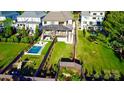 Aerial view of a backyard with a pool, play area, patio, and lush green lawn at 1214 S Kings Dr # A, Charlotte, NC 28207