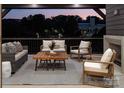 Relaxing covered patio with comfortable seating, fireplace, and tranquil evening ambiance at 1214 S Kings Dr # A, Charlotte, NC 28207